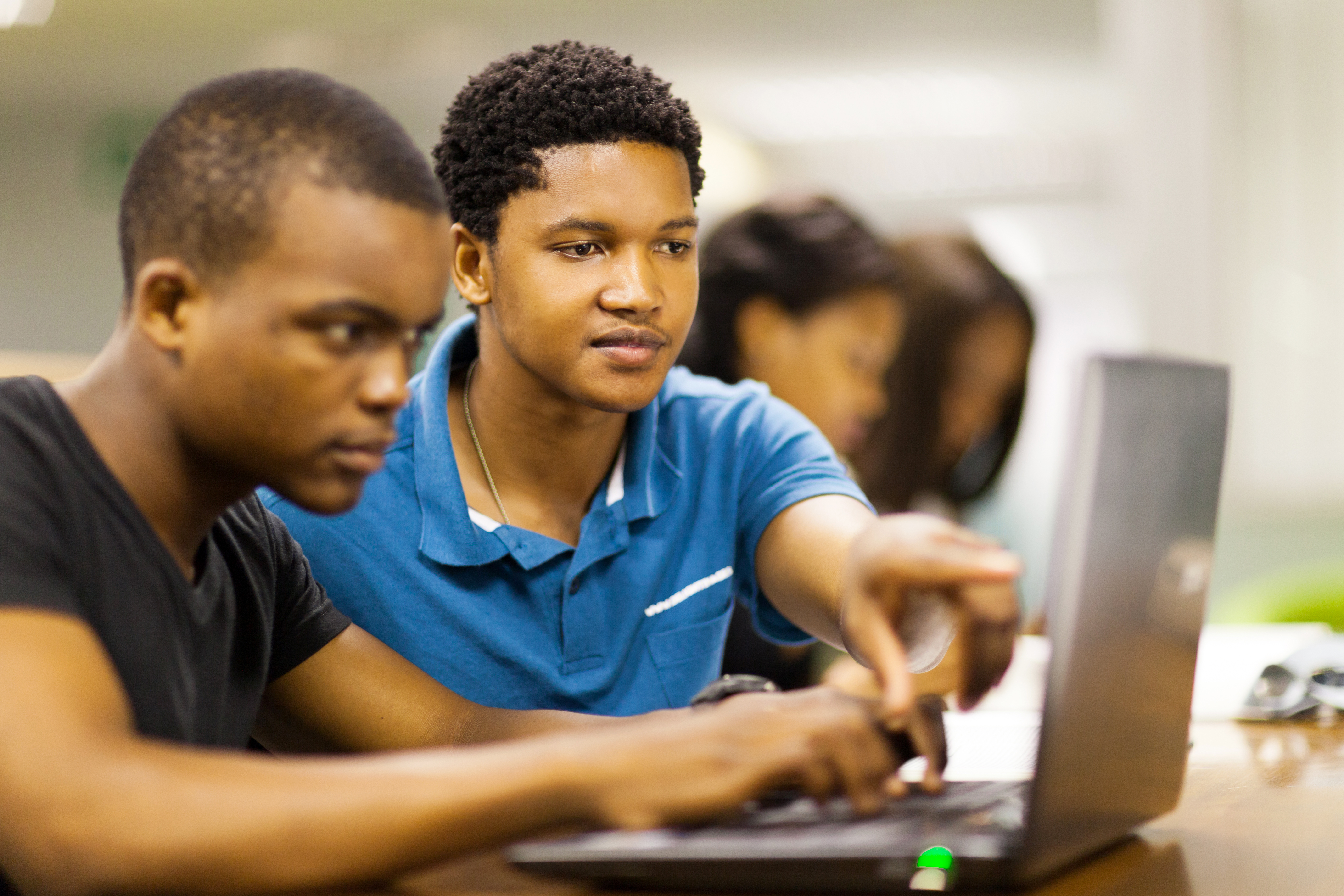 African American College Students Using Laptop Together